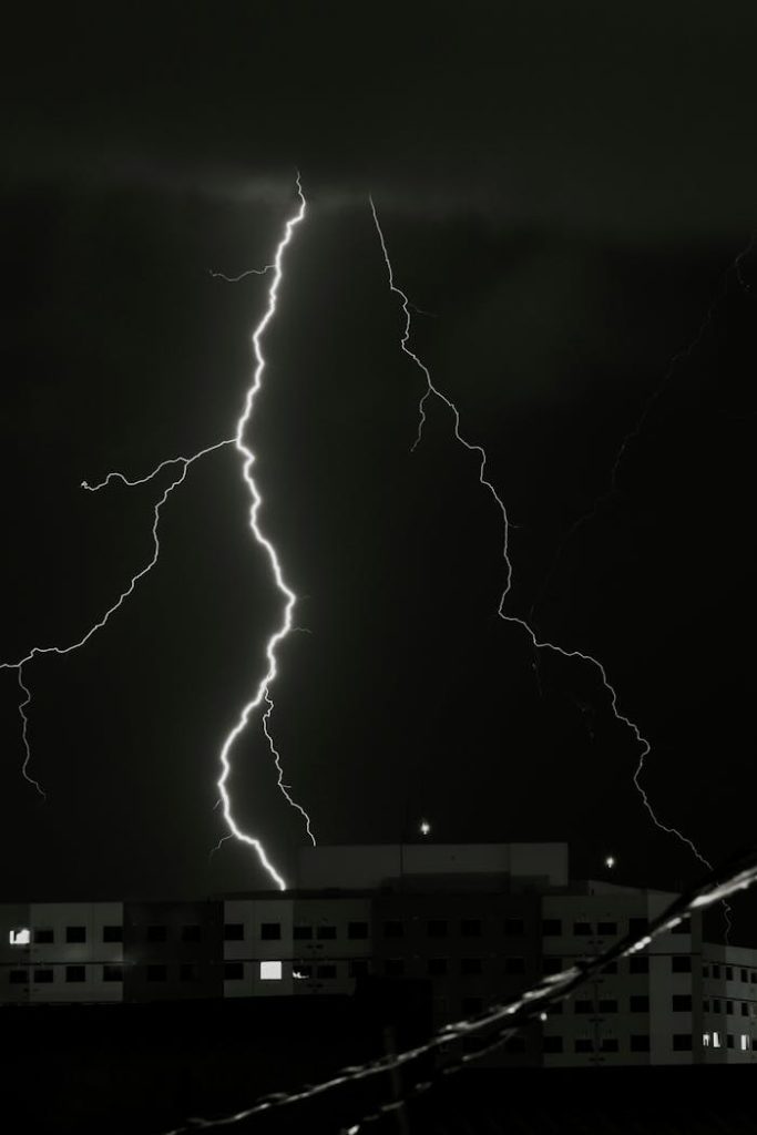 The Art of Drawing Readers In: Your attractive post title goes here A striking lightning bolt illuminates the sky above buildings during a stormy night.